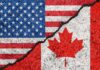 USA and Canada flags divided by jagged crack