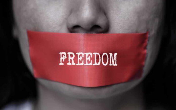 769303051 featured image Red tape over mouth with "FREEDOM" text.