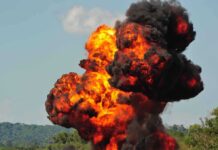 Large explosion with fireball and smoke cloud.