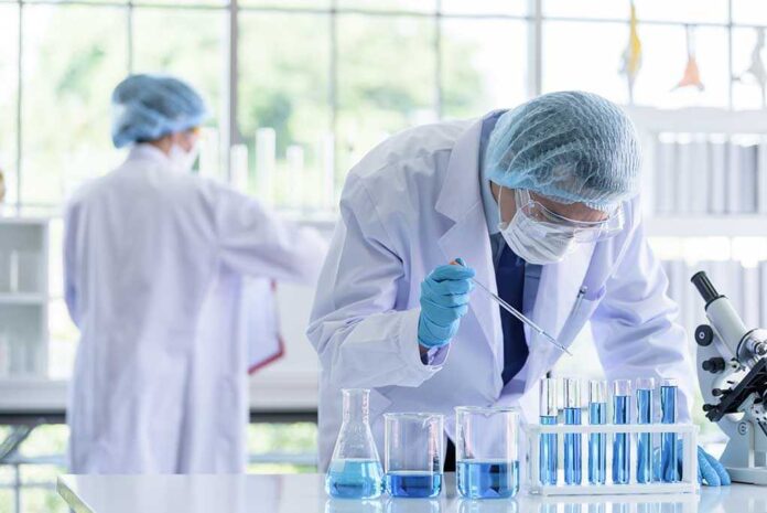 1365781304 featured image Scientists in lab coats conducting experiments with beakers