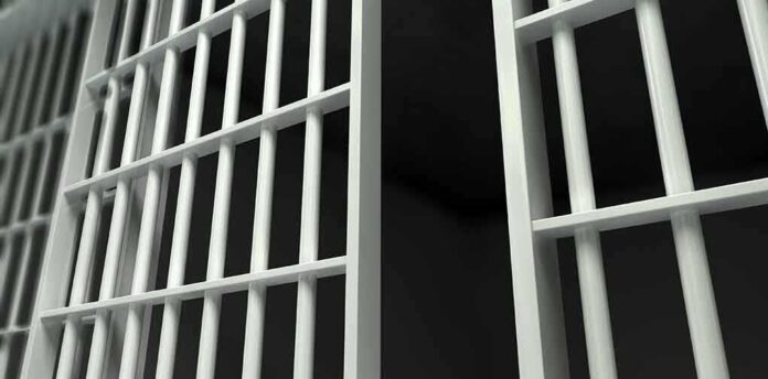 161438378 featured image Close-up of prison cell bars.