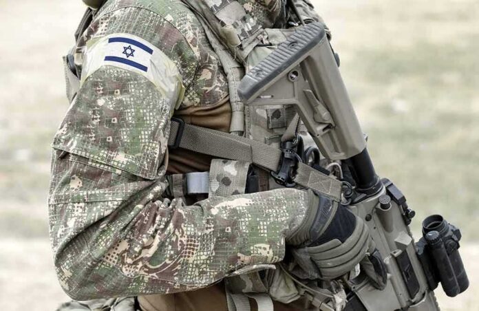 1917131027 featured image Soldier in camo uniform with Israeli flag patch.