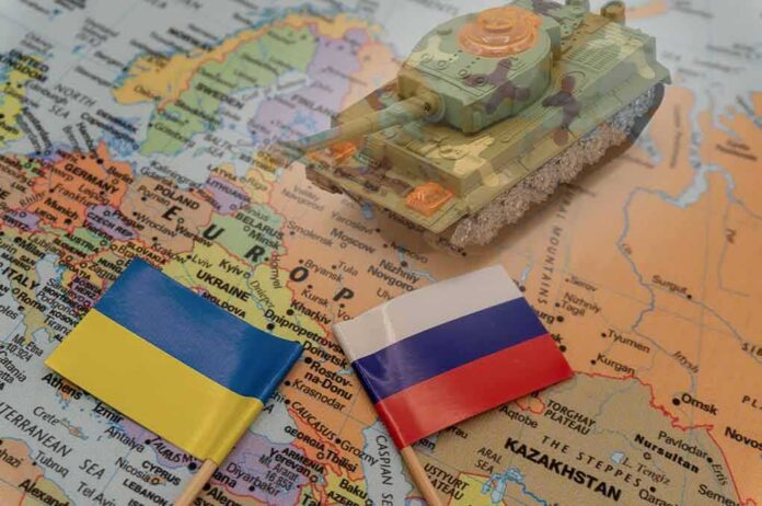 2114384846 featured image Toy tank on map with Ukraine and Russia flags
