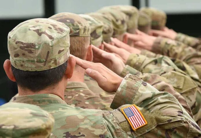 716351914 featured image Soldiers in uniform saluting with American flag patch