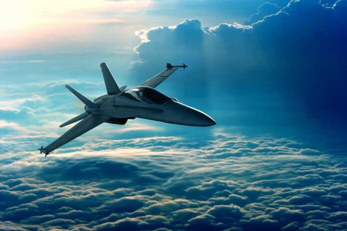92852002 featured image Jet flying above clouds in blue sky
