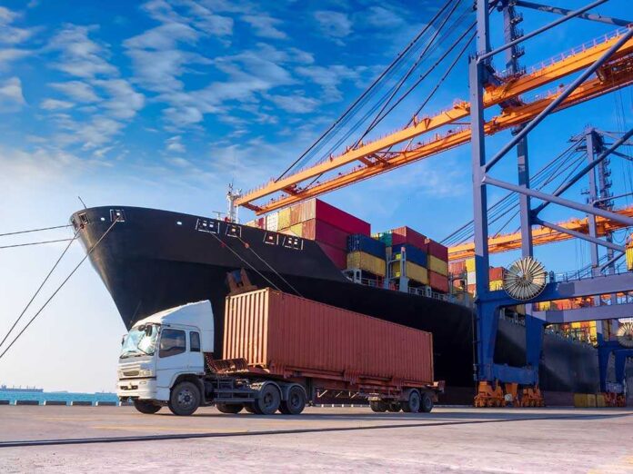 1038149395 featured image Cargo ship and truck at a busy port.