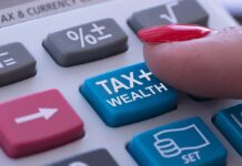 Finger pressing tax calculator button.
