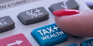 Finger pressing tax calculator button.