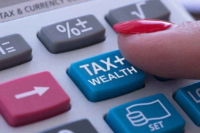 1762066592 featured image Finger pressing tax calculator button.