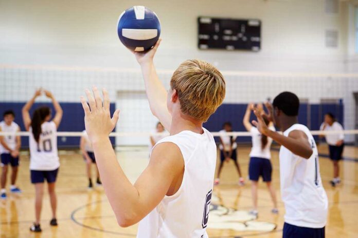 198896267 featured image Players about to serve a volleyball in gym
