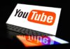 YouTube logo on a laptop and smartphone screen