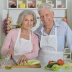 Elderly couple cooking together in the kitchen