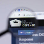 Magnifying glass focusing on US Department of Defense website