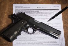 Gun and pen on firearm transaction form