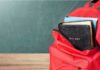 Red backpack with a Bible and books inside