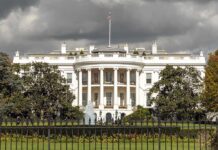 The White House with overcast sky and flag raised