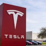 Bannon Accuses MUSK of Being SECURITY THREAT Tesla sign in front of dealership