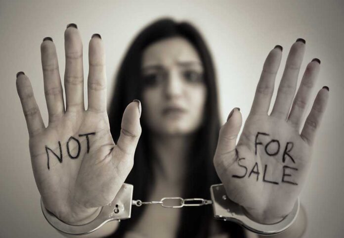 631031339 featured image Handcuffed woman shows NOT FOR SALE on her palms