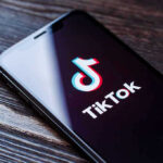 Phone screen showing TikTok logo and app