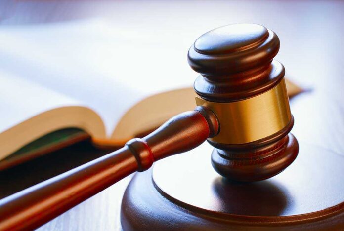 198453305 featured image Gavel resting on sounding block beside open book
