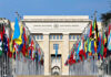 United Nations building with numerous national flags outside