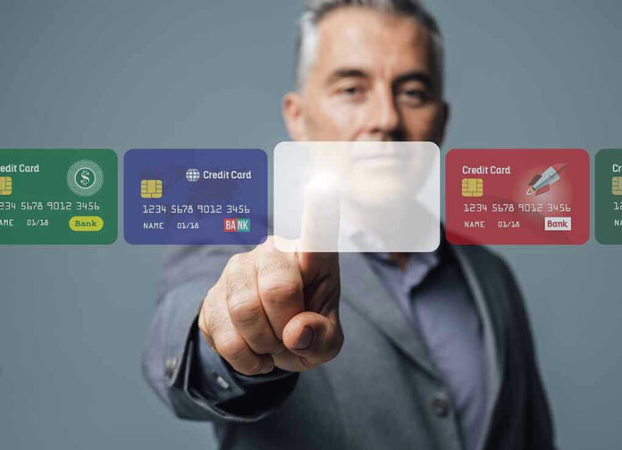 737497186 Man interacting with virtual credit card interface