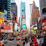 Times Square crowded with people and bright electronic advertisements