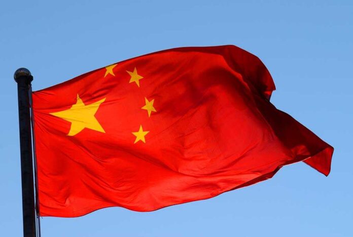 shutterstock_215706274.jpg Chinese flag waving against a clear blue sky