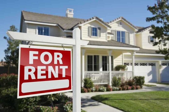 A house with a For Rent sign in the front yard