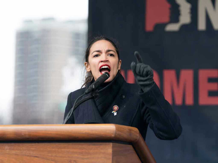 Woman passionately speaks at a podium outdoors.