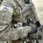 DETAINED – Thunberg ARRESTED By Israeli Military Forces! Soldier in camouflage gear with Israeli flag patch.