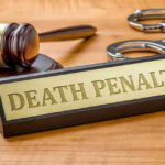 Basketball Star Faces DEATH PENALTY – Tragic Mistake! Gavel, handcuffs, and Death Penalty sign on desk.