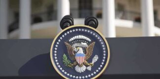 Close-up of the presidential seal on a podium