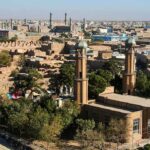 Anti-Semitic ATTACKS: Foreign Ties in Mosque Vandalism! Aerial view of a city featuring traditional buildings and minarets