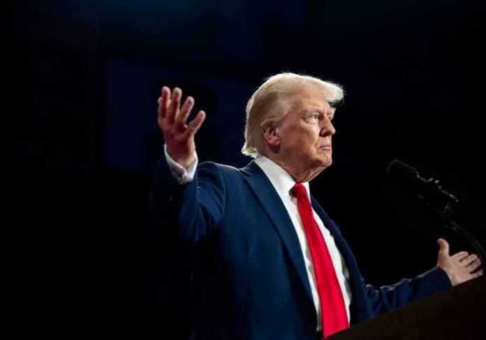 A man in a suit gesturing during a speech