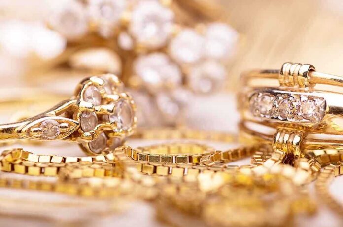 Close-up of various gold rings adorned with sparkling gems
