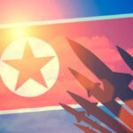 North Korea Unleashes Unstoppable Hypersonic Missile North Korean flag with missile silhouettes.