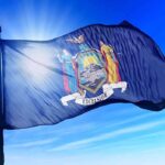 Mamdani Blasts Home Ownership as ‘White Supremacy’ New York state flag waving against a blue sky