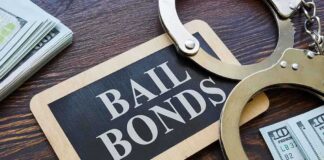 A bail bonds sign with handcuffs and stacks of cash