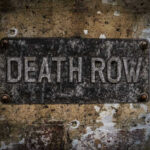 Weathered Death Row sign on aged concrete wall