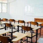 Outrage After Teachers Union DEMAND Children Protest ICE Empty classroom with desks, chairs, and whiteboard.