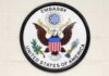 Seal of the United States Embassy featuring an eagle and the American flag