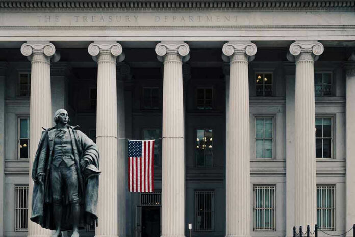 US Treasury Department building with statue and flag.