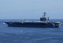 Missile Barrage SLAMS U.S Carrier – Intense Counter Offense! A large aircraft carrier sailing in the ocean