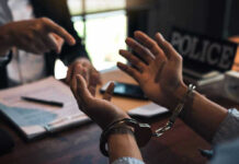 Person handcuffed in discussion with another person