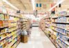 Supermarkets SNEAKILY Spying On You While You Shop! A grocery store aisle filled with various food products on shelves