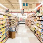Supermarkets SNEAKILY Spying On You While You Shop! A grocery store aisle filled with various food products on shelves