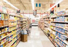 Supermarkets SNEAKILY Spying On You While You Shop! A grocery store aisle filled with various food products on shelves