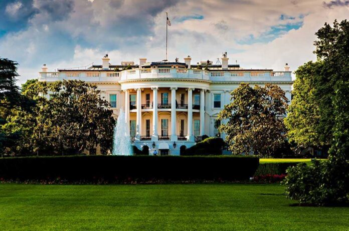 The,White,House,On,A,Beautiful,Summer,Day,,Washington,,Dc. The White House surrounded by greenery and a fountain in the foreground