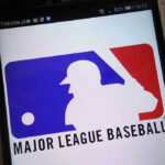 Hollywood Star Dares MLB — Faith Showdown! Major League Baseball logo on a smartphone screen.
